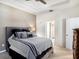 Primary bedroom featuring a gray color scheme, tray ceiling, and comfortable bed at 5714 Colony Glen Rd, Lithia, FL 33547