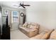 Neutral bedroom featuring comfortable sofa, window, and neutral colored walls at 5714 Colony Glen Rd, Lithia, FL 33547