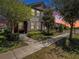Charming two-story home with landscaped yard and inviting walkway at dusk at 5714 Colony Glen Rd, Lithia, FL 33547