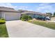 Charming single-story home featuring a two-car garage, well-maintained landscaping, and a concrete driveway on a sunny day at 5714 Colony Glen Rd, Lithia, FL 33547