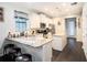 Open kitchen boasts an island with granite countertops and a breakfast bar with pendant lighting at 5714 Colony Glen Rd, Lithia, FL 33547