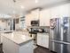 Bright kitchen featuring granite countertops, stainless steel appliances, and white cabinetry at 5714 Colony Glen Rd, Lithia, FL 33547
