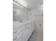 Bright bathroom featuring a white vanity, large mirror, and tiled shower-tub combination at 5980 Shore S Blvd # 312, Gulfport, FL 33707
