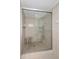 Modern bathroom shower with a glass door and neutral tile at 5980 Shore S Blvd # 312, Gulfport, FL 33707