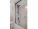 Bathroom featuring a shower-tub combination with glass doors and updated fixtures at 5980 Shore S Blvd # 312, Gulfport, FL 33707