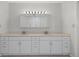 Bathroom with dual sinks, white cabinetry, a large mirror and tile flooring at 5980 Shore S Blvd # 312, Gulfport, FL 33707