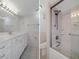 Bright bathroom featuring a white vanity, large mirror, and tiled shower-tub combination at 5980 Shore S Blvd # 312, Gulfport, FL 33707