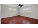 Bedroom with wood floors, ceiling fan, two windows, and neutral paint at 5980 Shore S Blvd # 312, Gulfport, FL 33707