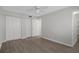 Bedroom with a ceiling fan, wood floor, and closets at 5980 Shore S Blvd # 312, Gulfport, FL 33707