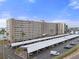 Stunning high-rise condo building featuring covered parking, mature landscaping and serene waterfront views at 5980 Shore S Blvd # 312, Gulfport, FL 33707