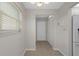 Hallway has neutral paint, tile floors, a window, and a door with a closet nearby at 5980 Shore S Blvd # 312, Gulfport, FL 33707