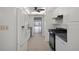 Open concept kitchen with white cabinets, black appliances, and tiled flooring at 5980 Shore S Blvd # 312, Gulfport, FL 33707