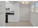 Bright kitchen features white cabinets, black appliances, tile flooring, and a large window at 5980 Shore S Blvd # 312, Gulfport, FL 33707