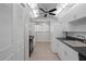 Charming kitchen with white cabinets, black appliances, and tiled flooring at 5980 Shore S Blvd # 312, Gulfport, FL 33707