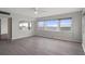 Bright living room featuring luxury vinyl floors, neutral walls, and large windows with beautiful water views at 5980 Shore S Blvd # 312, Gulfport, FL 33707