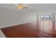 Bright, expansive living room with hardwood floors, ceiling fan, and large windows providing abundant natural light at 5980 Shore S Blvd # 312, Gulfport, FL 33707