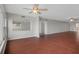 Open floor plan in living room showcasing hardwood floors, large picture windows, and views into other living spaces at 5980 Shore S Blvd # 312, Gulfport, FL 33707