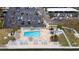 Beautiful community pool area with lounge chairs, tiki umbrellas, and mature landscaping at 5980 Shore S Blvd # 312, Gulfport, FL 33707