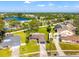 Aerial view of the property showcasing the neighborhood, nearby lake, and lush green surroundings at 6070 Denver Ne St, St Petersburg, FL 33703