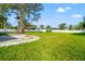 Spacious grassy backyard featuring a brick barbecue and paver patio with fire pit at 6070 Denver Ne St, St Petersburg, FL 33703
