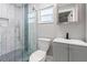 Bathroom featuring a glass shower with decorative tile, updated toilet and a vanity with black faucet at 6070 Denver Ne St, St Petersburg, FL 33703