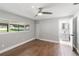 Bedroom with hardwood floors, a ceiling fan and a large window overlooking the backyard at 6070 Denver Ne St, St Petersburg, FL 33703