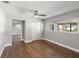 Bedroom featuring hardwood floors, a ceiling fan and a large window overlooking the backyard at 6070 Denver Ne St, St Petersburg, FL 33703
