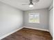 Bedroom featuring hardwood floors, a ceiling fan and a large window with blinds at 6070 Denver Ne St, St Petersburg, FL 33703