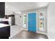Bright entryway features a striking blue door, tile floors, and seamless transition to the kitchen at 6070 Denver Ne St, St Petersburg, FL 33703