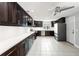 Spacious kitchen featuring dark cabinets, stainless steel appliances, and white countertops at 6070 Denver Ne St, St Petersburg, FL 33703