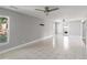 Spacious living room with tile flooring, ceiling fan, and natural light from the window at 6070 Denver Ne St, St Petersburg, FL 33703