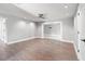 Spacious living room with sleek wood floors, recessed lighting, and seamless transition to other living spaces at 6070 Denver Ne St, St Petersburg, FL 33703