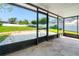 Screened patio with concrete flooring and a beautiful backyard view with a brick fire pit at 6070 Denver Ne St, St Petersburg, FL 33703