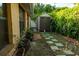 A backyard with a small storage shed and a walkway at 631 Luzon Ave, Tampa, FL 33606