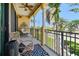Relaxing covered balcony with comfortable seating, a ceiling fan, and pleasant neighborhood views at 6412 Mayra Shores Ln, Apollo Beach, FL 33572