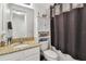 Bright bathroom with granite countertop, white cabinetry, and combination tub/shower at 6412 Mayra Shores Ln, Apollo Beach, FL 33572