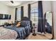 Stylish bedroom with dark accents, a cozy upholstered headboard, and large windows for ample natural light at 6412 Mayra Shores Ln, Apollo Beach, FL 33572