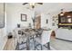 Elegant dining area with a rustic wood table, comfortable seating, and a view of the living area at 6412 Mayra Shores Ln, Apollo Beach, FL 33572