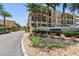 Beautiful yellow townhomes, manicured landscaping and a community sign reading: Brisa Del Mar Luxury Townhomes at 6412 Mayra Shores Ln, Apollo Beach, FL 33572