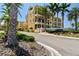 Beautiful yellow townhomes, manicured landscaping and a community sign reading: Brisa Del Mar Luxury Townhomes at 6412 Mayra Shores Ln, Apollo Beach, FL 33572