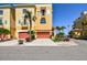 Beautiful yellow townhome with red garage doors and lush tropical landscaping at 6412 Mayra Shores Ln, Apollo Beach, FL 33572