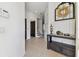 Bright foyer features neutral tile, a dark wood table and an open staircase at 6412 Mayra Shores Ln, Apollo Beach, FL 33572