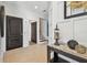 Bright foyer features neutral tile, a dark wood table and an open staircase at 6412 Mayra Shores Ln, Apollo Beach, FL 33572