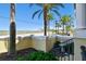 Charming courtyard entrance with tropical plants and serene street view, enhancing curb appeal at 6412 Mayra Shores Ln, Apollo Beach, FL 33572