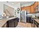 Well-appointed kitchen boasting granite counters, stainless steel fridge, and wood cabinets, offering ample space at 6412 Mayra Shores Ln, Apollo Beach, FL 33572
