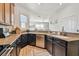 Gorgeous kitchen with granite countertops, black cabinets, and stainless steel appliances, perfect for cooking at 6412 Mayra Shores Ln, Apollo Beach, FL 33572