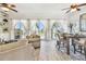 Bright living room featuring ocean views from large windows with elegant sheer curtains and an adjacent dining area at 6412 Mayra Shores Ln, Apollo Beach, FL 33572