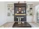 Cozy living room with a modern fireplace, built-in shelving, and a large television for entertainment at 6412 Mayra Shores Ln, Apollo Beach, FL 33572