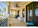 Covered patio offering shade and outdoor relaxation, complemented by tropical landscaping at 6412 Mayra Shores Ln, Apollo Beach, FL 33572