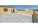 Large rooftop area with gray tile, partial privacy walls, and distant water views, perfect for entertaining at 6412 Mayra Shores Ln, Apollo Beach, FL 33572